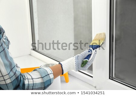 Zdjęcia stock: Woman Painting The Window Frame