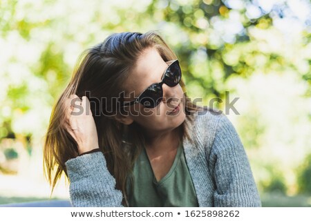 Beautiful Elegant Woman Sitting And Fixes Her Hair Imagine de stoc © Madrolly