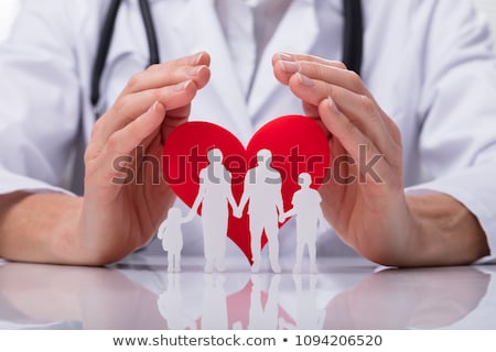 Stockfoto: Doctor Protecting Family Cut Out And Heart Shape