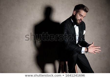 Stock fotó: Man Holding His Hands Together Sitting On A Stool
