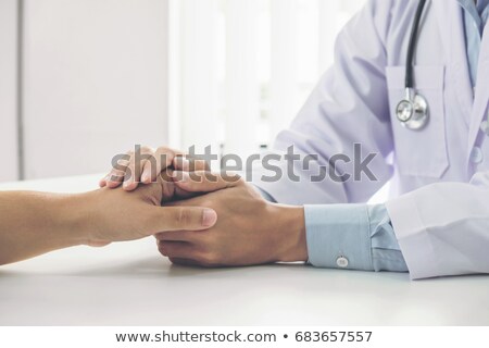 Foto stock: Close Up Of Doctor Touching Patient Hand For Encouragement And E
