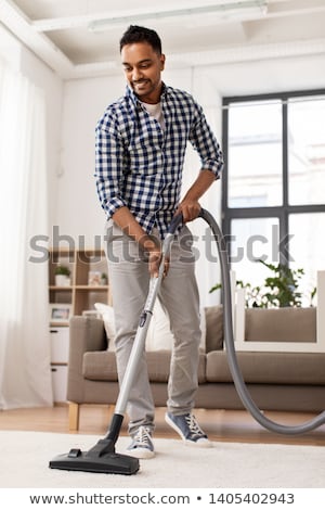 Stock fotó: Indian Man With Vacuum Cleaner At Home