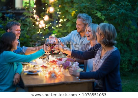 Stockfoto: Friends Clinking Drinks At Home In Evening