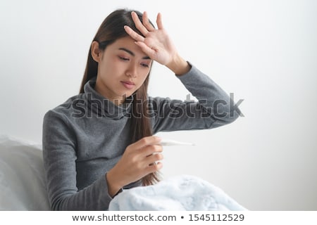 Stock photo: Woman Taking Her Body Temperature