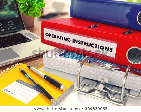 ストックフォト: Operating Instructions On Red Office Folder Toned Image