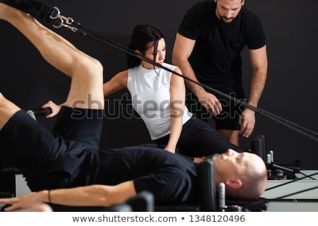 Stock photo: Pilates Reformer Woman Down Stretch Exercise