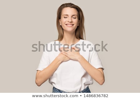 Stok fotoğraf: Hand Holding Model Heart On Chest