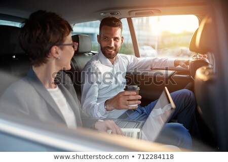 Foto stock: Man And Woman On Backseat Of Luxury Car