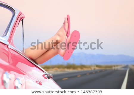 Foto stock: Relaxed Woman In Pink Car On Road Trip Vacation