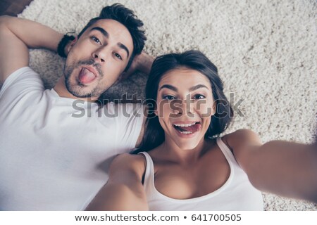 Stock foto: Couple Lying On Floor And Making Selfie At Home