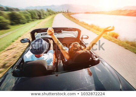 [[stock_photo]]: Happy Man And Woman Driving In Cabriolet Car