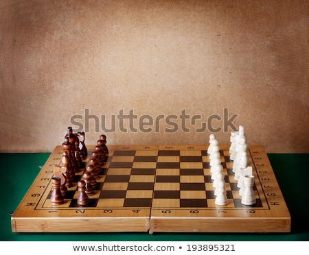 Stok fotoğraf: Wooden Chess Board With Figures On Green Table And Old Wall