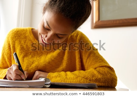 Foto stock: Young Woman Writes To Black Diary