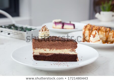 Foto stock: Fudge Pieces On Light Wood Table With Black Background