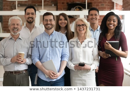 Foto stock: Young Businessman With Senior Clients Standing In Office