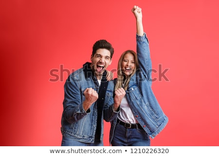 ストックフォト: Portrait Of A Cheerful Young Man Dressed In Denim Jacket