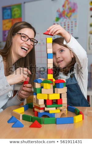 Stock foto: Daycare Worker Playing With Colorful Wooden Toy Blocks