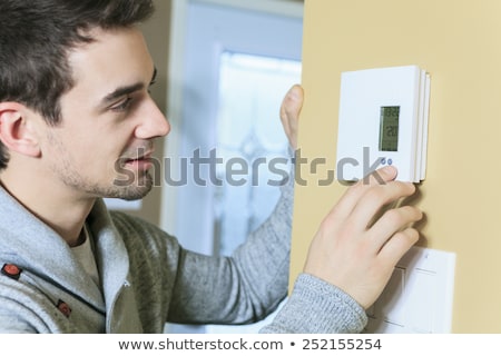 Сток-фото: Man Set The Thermostat At House