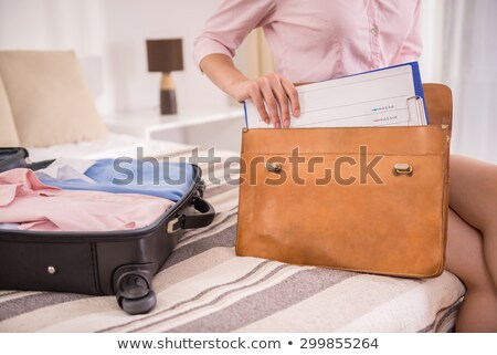 Stok fotoğraf: Young Elegant Woman With Luggage Standing In Hotel Room And Talking To Porter