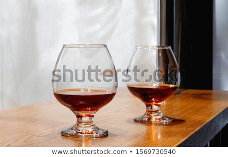 Stock fotó: Two Goblets Of Brandy On Wooden Old Counter Top