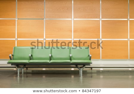 Foto stock: Metal Chairs Against Wall