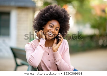 ストックフォト: Smiling Woman Talking On Mobile Phone In Park