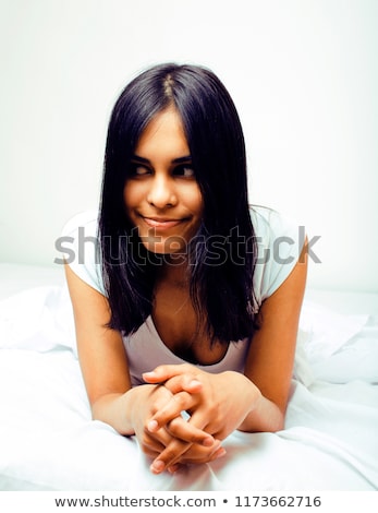 Foto d'archivio: Young Pretty Tann Woman In Bed Among White Sheets Having Fun Tr