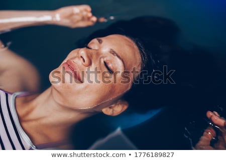 Zdjęcia stock: Young Woman Resting In Floating Tank