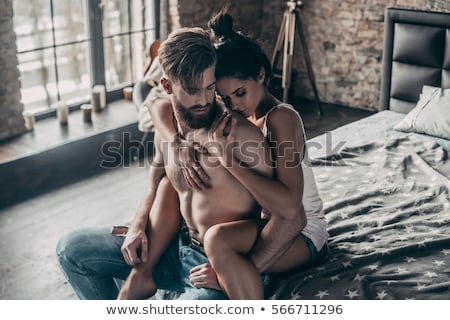 Foto stock: The Loving Affectionate Heterosexual Couple On Bed