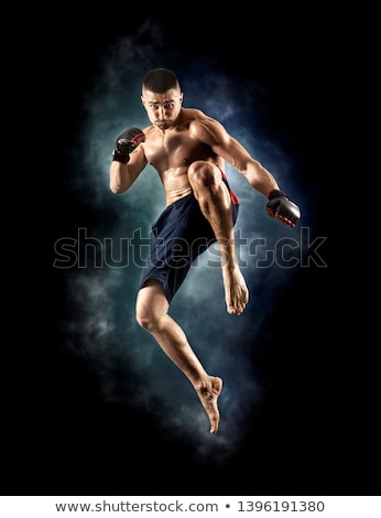 Stockfoto: Adult Athlete Is Training Punch The Hand In Jump