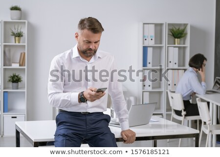 [[stock_photo]]: Mature Male Entrepreneur Or Employer Texting Or Scrolling In Smartphone On