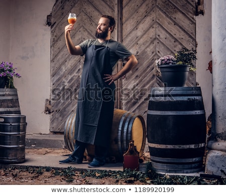 Foto stock: Brewer With Beer Barrel In Brewery