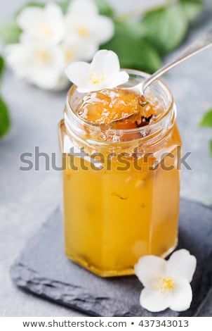 Foto stock: Jasmine Flower Confiture Jam With Fresh Jasmine Flowers Grey Stone Slate Background