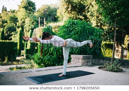 Stock photo: Full Length Of Graceful Woman Athlete Standing And Stretching Hands