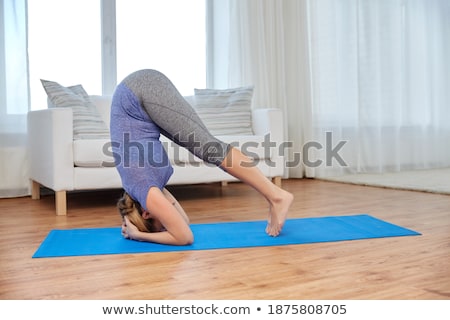 Zdjęcia stock: Woman Making Yoga In Headstand Pose On Mat