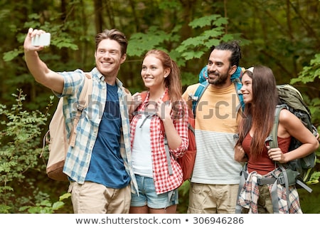 Stok fotoğraf: Friends With Backpack Taking Selfie By Smartphone
