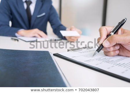 Foto d'archivio: Interviewer Or Board Reading A Resume During A Job Interview Em