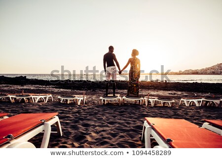 Zdjęcia stock: Young Couple Having Fun Near The Ocean At Sunset