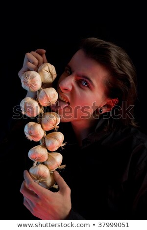 Stock photo: Vampire Licking Garlic