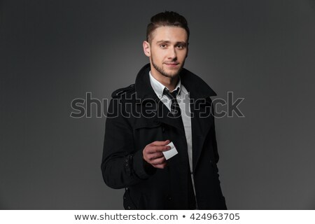 Сток-фото: Businessman In Black Coat And Tie Giving Blank Business Card