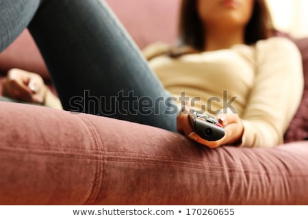 Stok fotoğraf: Female Hand With Television Remote Control