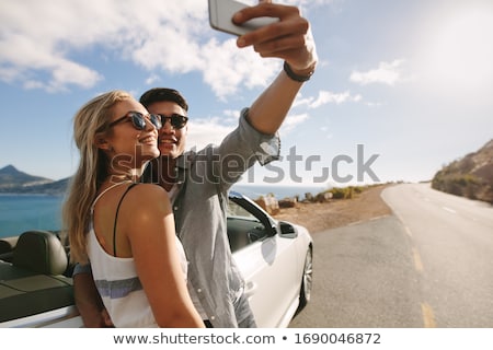 [[stock_photo]]: Young Woman With Smartphone At Convertible Car