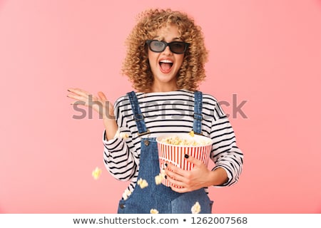 Stok fotoğraf: Photo Of Young Curly Woman 20s Holding Popcorn Bucket While Stan