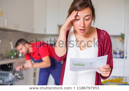 Stock photo: Housewife Shocked After Reading Repair Invoice