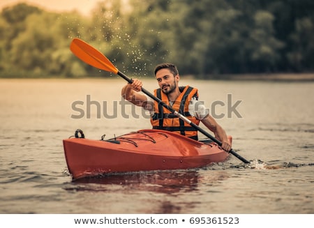 Foto d'archivio: Handsome Man Kayaking On Lake Sea