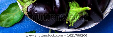 Foto stock: Banner Of Fresh Eggplant In Grey Basket On Blue Wooden Table