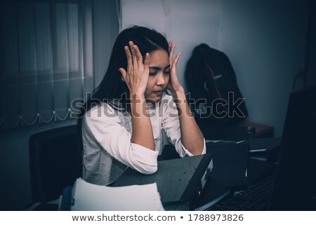 Stockfoto: Office Worker Looking At Stacks Of Files