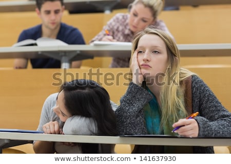 Stock foto: Students In A Lecture With One Woman Looking Up In College