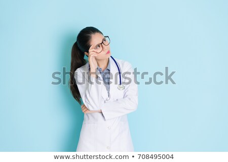 [[stock_photo]]: Daydreaming Female Doctor In Hospital