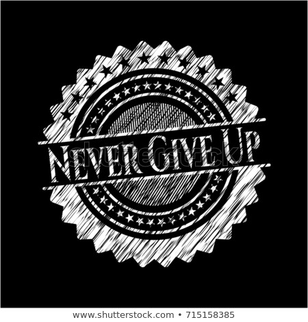 Foto stock: Never Give Up Text On Green Board